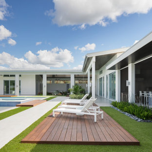 Example of a huge trendy backyard tile and custom-shaped lap hot tub design in Tampa
