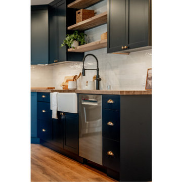 Navy Shaker Kitchen with White Farmhouse Sink and Floating Wood Shelves