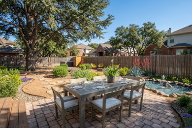 Inspiration for a mid-sized mediterranean backyard decomposed granite patio kitchen remodel in Austin