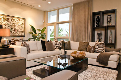 Example of a mid-sized trendy open concept brown floor living room design in Chicago with beige walls, a standard fireplace, a stone fireplace and a media wall