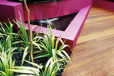 Inspiration for a small contemporary courtyard patio in Perth with a water feature.