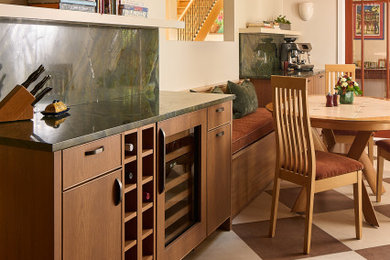 Eat-in kitchen - mid-sized mid-century modern u-shaped ceramic tile, multicolored floor and exposed beam eat-in kitchen idea in Baltimore with flat-panel cabinets, medium tone wood cabinets, quartzite countertops, multicolored backsplash, subway tile backsplash, stainless steel appliances, a peninsula, green countertops and an undermount sink