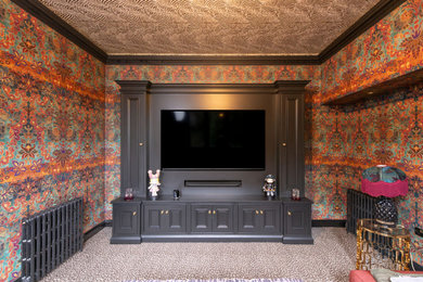 This is an example of a medium sized traditional formal enclosed living room feature wall in Hertfordshire with multi-coloured walls, carpet, a built-in media unit, multi-coloured floors and wallpapered walls.