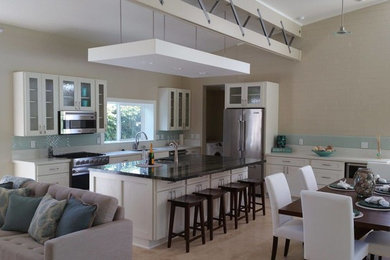 Example of a mid-sized transitional single-wall beige floor open concept kitchen design in Hawaii with an undermount sink, shaker cabinets, white cabinets, blue backsplash, glass tile backsplash, stainless steel appliances, an island and brown countertops