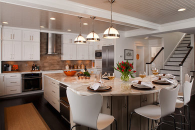 Inspiration for a large transitional u-shaped dark wood floor eat-in kitchen remodel in Other with an undermount sink, shaker cabinets, white cabinets, granite countertops, brown backsplash, porcelain backsplash, stainless steel appliances and an island
