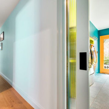 Light Blue Pocket Door Leads to Large Colorful Laundry/Mud Room