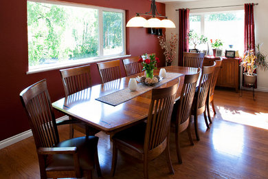 Enclosed dining room - mid-sized traditional medium tone wood floor enclosed dining room idea in Other with red walls