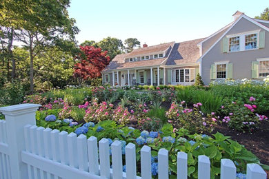 This is an example of a mid-sized traditional full sun front yard formal garden in Boston.