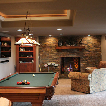 Eye-popping Denver Basement Remodel with hidden bookcase doors and tray ceilings