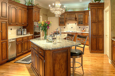Large transitional l-shaped kitchen photo in Kansas City with raised-panel cabinets