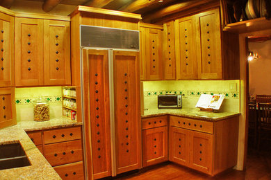 Mid-sized mountain style u-shaped dark wood floor and brown floor enclosed kitchen photo in Albuquerque with a double-bowl sink, shaker cabinets, light wood cabinets, granite countertops, beige backsplash, travertine backsplash, paneled appliances and no island