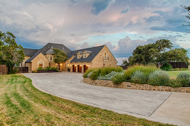 Inspiration for a huge mediterranean beige two-story stone exterior home remodel in Austin with a shingle roof