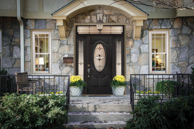 Entryway - mid-sized traditional entryway idea in Detroit with a black front door