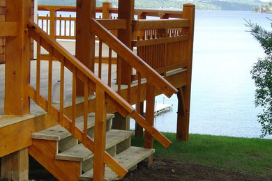 Large backyard deck photo in Burlington with a roof extension