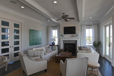 Living room - mid-sized coastal open concept dark wood floor and brown floor living room idea in Charleston with gray walls, a standard fireplace, a tile fireplace and a wall-mounted tv