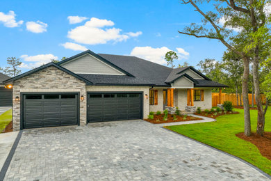 Mid-sized farmhouse white one-story brick exterior home idea in Other with a hip roof, a shingle roof and a black roof