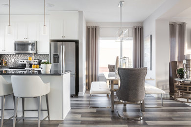 This is an example of a mid-sized contemporary kitchen/dining combo in Edmonton with laminate floors, multi-coloured floor, grey walls and no fireplace.