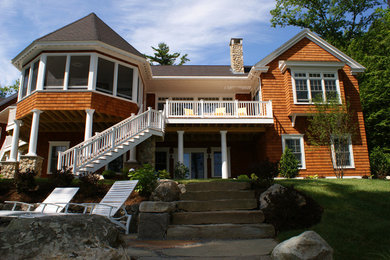 Large elegant brown one-story mixed siding exterior home photo in Portland Maine