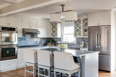 Kitchen pantry - transitional light wood floor kitchen pantry idea in Other with a single-bowl sink, shaker cabinets, white cabinets, quartzite countertops, gray backsplash, stone slab backsplash, stainless steel appliances and an island