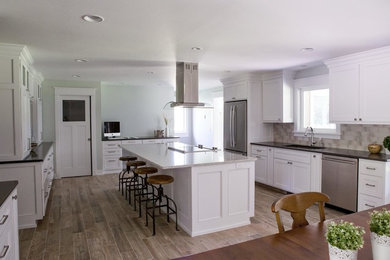Large arts and crafts u-shaped porcelain tile eat-in kitchen photo in Grand Rapids with an undermount sink, shaker cabinets, white cabinets, quartzite countertops, beige backsplash, subway tile backsplash, stainless steel appliances and an island