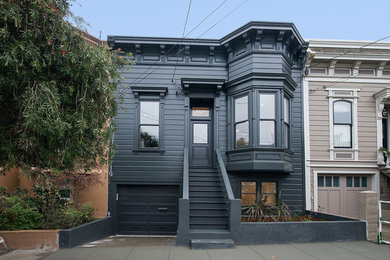 Inspiration for a mid-sized traditional two-storey black exterior in San Francisco with wood siding and a flat roof.