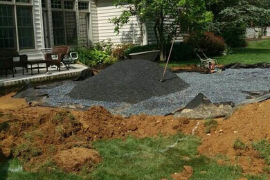 Example of a large trendy backyard concrete paver patio kitchen design in Philadelphia with a pergola
