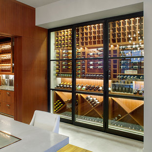 This is an example of a modern wine cellar in Austin with storage racks.