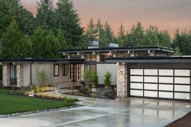 Design ideas for a mid-sized contemporary one-storey grey house exterior in Seattle with concrete fiberboard siding, a flat roof and a mixed roof.