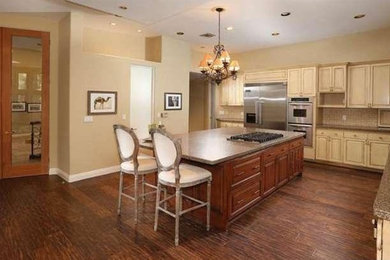 Large southwest eat-in kitchen photo in Los Angeles with shaker cabinets, granite countertops and an island