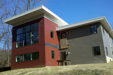 Large contemporary multicolored two-story wood flat roof idea in Cincinnati