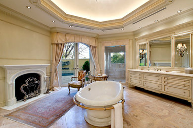 Example of a mid-sized classic master light wood floor doorless shower design in Las Vegas with raised-panel cabinets, dark wood cabinets, a one-piece toilet, beige walls, a drop-in sink and soapstone countertops