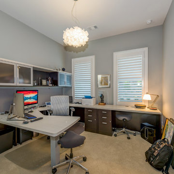 His Home Office with commercial grade furniture (wide angle distorts this room's