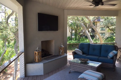 Example of a large beach style backyard patio design in Atlanta with a roof extension