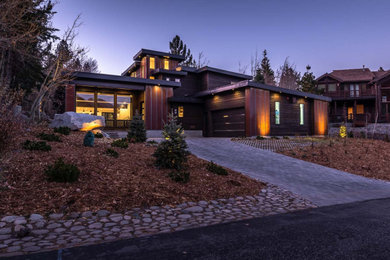 Large modern brown two-story mixed siding house exterior idea in Orange County with a metal roof and a black roof