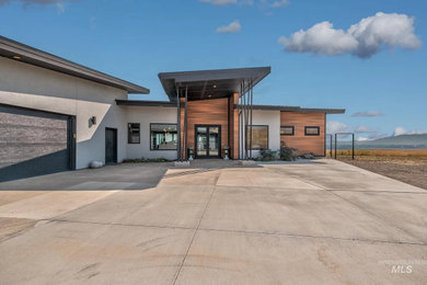Large one-story mixed siding exterior home photo in Boise with a metal roof and a black roof