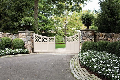 Photo of a large traditional front yard full sun driveway for spring in New York with gravel and a garden path.