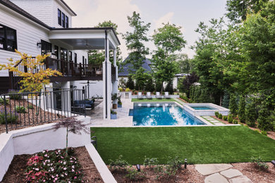 Inspiration for a large transitional backyard stone and rectangular pool remodel in Raleigh