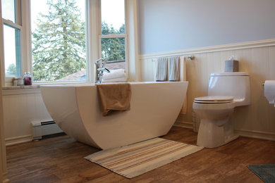 Large minimalist porcelain tile porcelain tile freestanding bathtub photo in Philadelphia with a one-piece toilet and blue walls