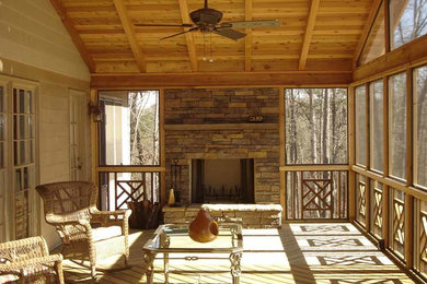 Mid-sized elegant screened-in back porch photo in Dallas with decking and a roof extension