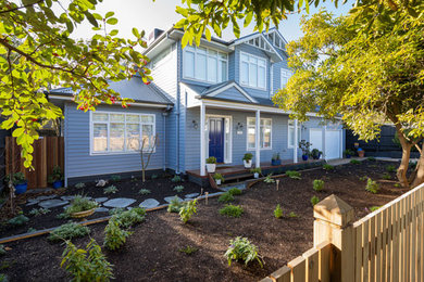 This is an example of a small traditional two-storey blue house exterior in Melbourne with wood siding, a gable roof and a metal roof.