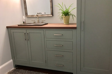 Inspiration for a bathroom in Philadelphia with flat-panel cabinets, green cabinets, wooden worktops and a built in vanity unit.