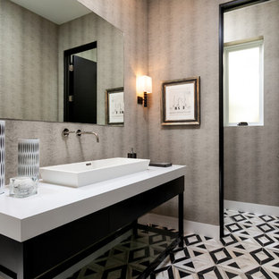 Large trendy multicolored floor powder room photo in Orange County with a vessel sink, white countertops, flat-panel cabinets, black cabinets and gray walls