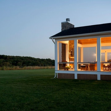 Design Builders screened porch with stone fireplace & Ipe deck in Sykesville MD