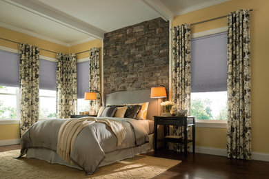 Example of a large transitional master dark wood floor and brown floor bedroom design in Other with yellow walls and no fireplace