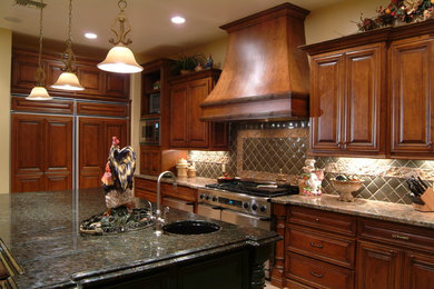 Large country l-shaped open concept kitchen photo in Phoenix with an undermount sink, raised-panel cabinets, dark wood cabinets, granite countertops, multicolored backsplash, ceramic backsplash, stainless steel appliances and an island