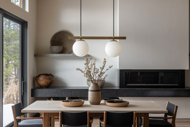 Large minimalist medium tone wood floor, beige floor and exposed beam kitchen/dining room combo photo in Phoenix with white walls