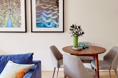 Photo of a small contemporary open concept living room in Sydney with beige walls and light hardwood floors.