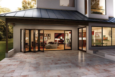 Example of a large transitional backyard tile patio design in Orange County with no cover