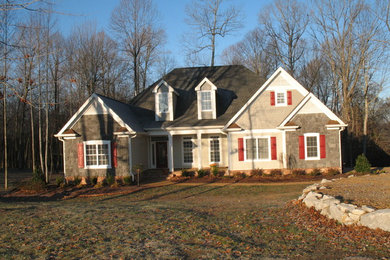 Mid-sized elegant beige two-story stone house exterior photo in Nashville with a shingle roof