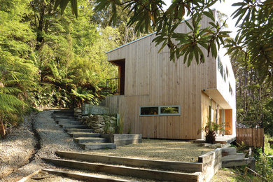 This is an example of a mid-sized contemporary two-storey exterior in Hobart with wood siding.